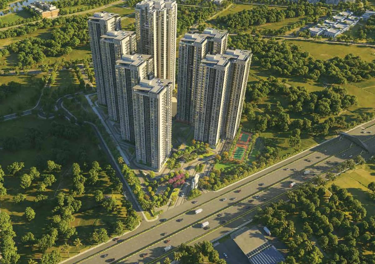 Aerial view of the Sattva Aangane towers above the greens and Old Madras Road, artist's impression