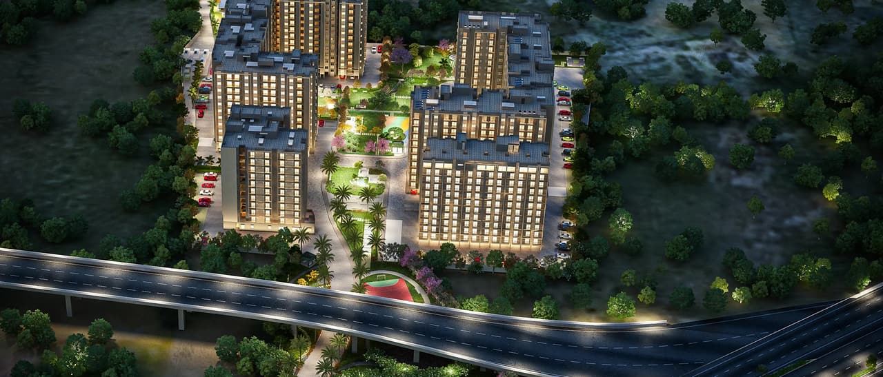 Sattva Aeropolis at night from the air: the lit blocks around the central garden beside the NH 44 flyover, artist's impression