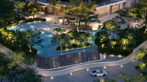 A landscaped water court lit at night beside the drive at Sattva City, artist's impression
