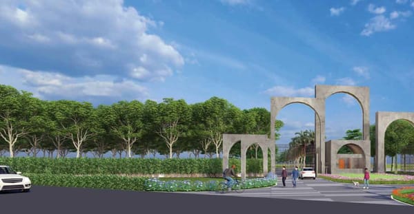 The entrance arches and the tree line along the main road at Sattva Green Groves, artist's impression