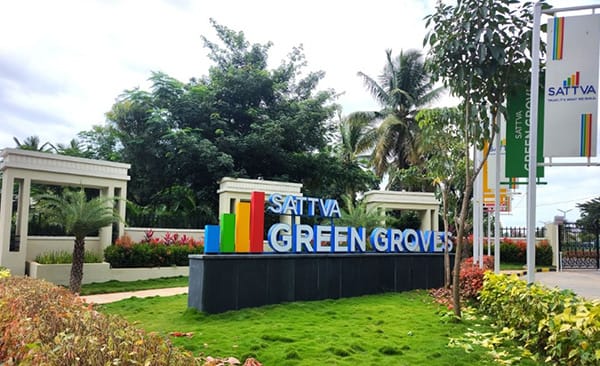 The Sattva Green Groves sign at the entry portal, site photo, September 2026
