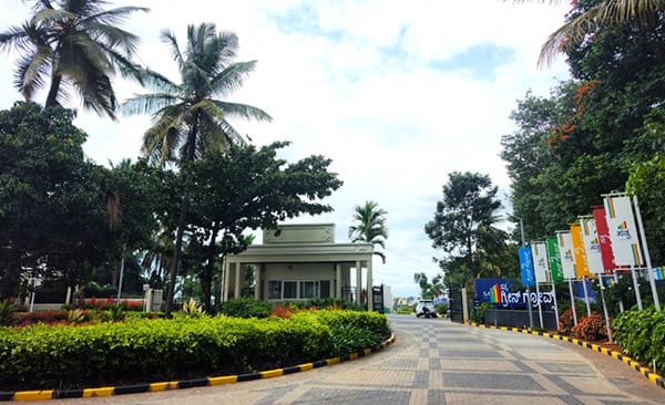 The entry road at Sattva Green Groves, site photo, September 2026