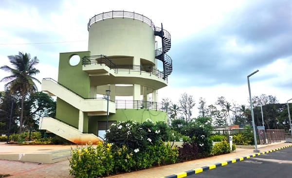 The overhead water tank at Sattva Green Groves, site photo, September 2026