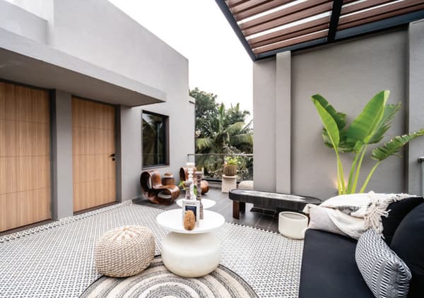 A private terrace under a pergola, photographed at the property as the developer's brochure notes