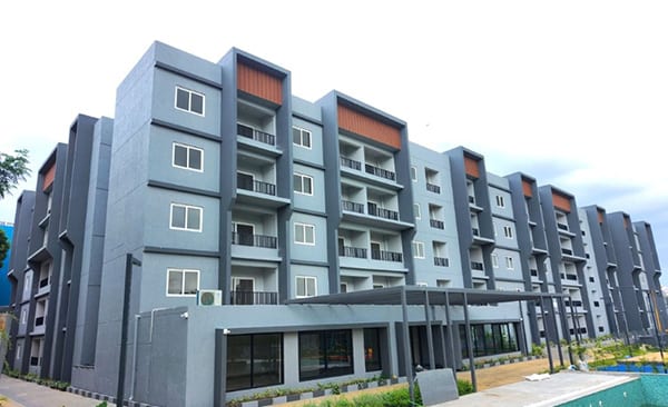 The clubhouse of Sattva SimpliCity beside the pool, site photo from the developer