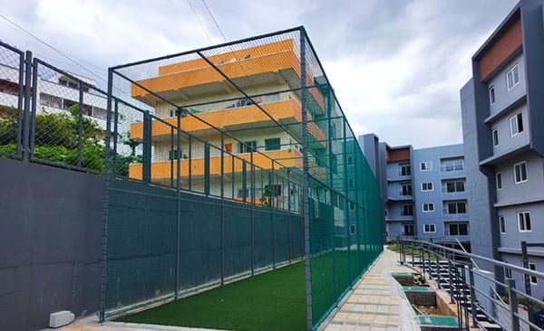 The net cricket pitch along a block at Sattva SimpliCity, site photo from the developer