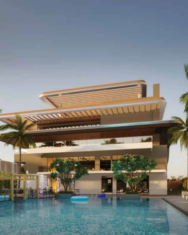 The main clubhouse of Sattva Songbird above its swimming pool at dusk, artist's impression
