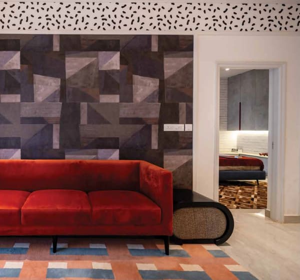 Living room of the model apartment with a red sofa, a representational photograph