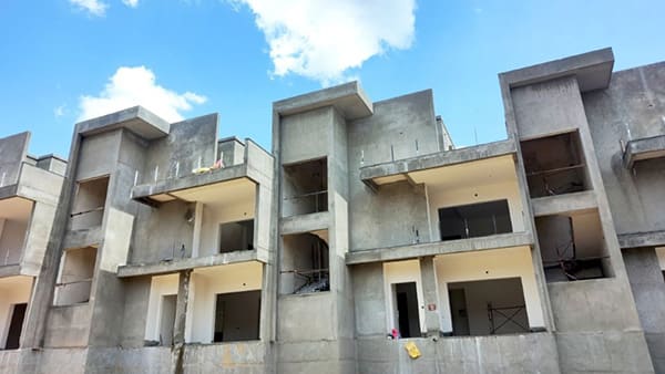 Block 6 at Sattva Springs with plastering completed and flooring under way, a site photo from September 2026
