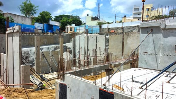 The clubhouse block at Sattva Springs under construction, a site photo from September 2026